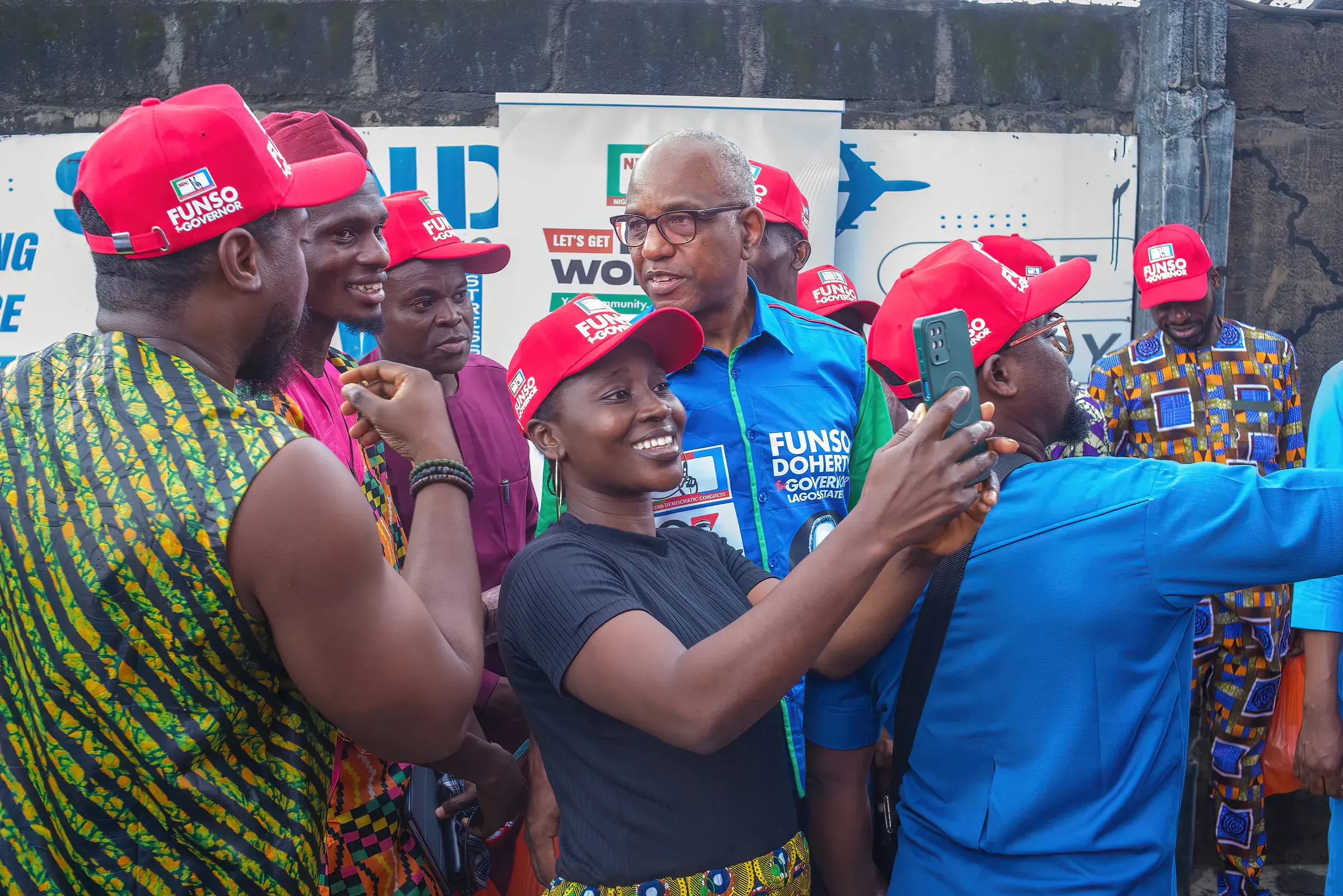 Funso Doherty with people during his visit to Alimosho.