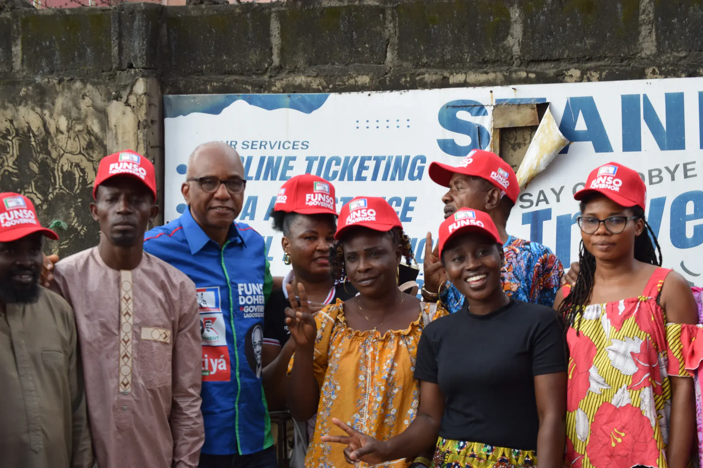 Funso Doherty with people during his visit to Alimosho.